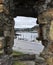 Attractive View of boats in Conwy port framed by window in rocks Wales