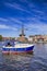 Attractive View of Harlem Sight With De Adriaan Windmill on Spaarne River And Sailing Boat In Foreground At Noon