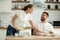 Attractive wife serving food cooked for husband in the kitchen