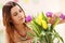 Attractive woman arranging tulips flowers in vase