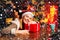 Attractive woman in a Christmas room. Pretty woman celebrating new year or an event. Beauty fashion girl with Christmas