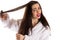 Attractive woman combing hair with sad face
