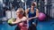 Attractive woman doing exercises for the press under the supervision of a coach