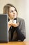 Attractive woman dreaming with coffee cup at working place