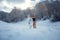 Attractive woman dressed in swimsuit with snowboard on the slope