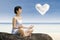 Attractive woman exercise yoga under love cloud at beach