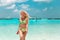 Attractive Woman in fashionable bikini on tropical beach. Pretty slim girl posing on exotic island in turquoise ocean.  Blonde