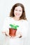 Attractive woman gifting green plant