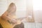 Attractive woman with guitar sitting in light room with wooden floor. Musician, concert, hobby, leisure, rehearsal