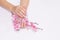 Attractive woman hand manicure with long acrylic extension stiletto style painting sweet ombre pink glitter decorated with