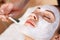 Attractive woman having mask in spa salon
