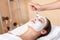 Attractive woman having mask in spa salon