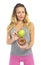 Attractive woman holding apple and chocolate donut in healthy fruit versus sweet junk food temptation