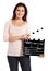 Attractive woman holding clapperboard