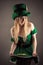 Attractive woman in image leprechaun with coins in skirt