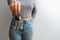 An attractive woman in jeans and a top holds out a bunch of keys in her hand. People lifestyle concept. Mock up copy space. Hold