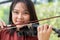 An attractive woman learning musician plays the violin at home. Composer creating songs with string instruments. Dreamy violinist