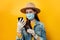 Attractive woman in medical sterile face mask gloves, holding phones in hands shopping in app checking social media