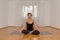 Attractive woman meditating alone in a room