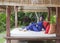 Attractive woman in a Muslim swimwear burkini in gazebo for rest in a garden