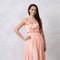 Attractive woman in nude elegant ball gown