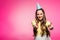 attractive woman with party hat showing thumbs up