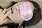 Attractive woman with pink sleeping blindfold