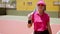 Attractive woman player walking on a tennis court