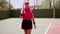 Attractive woman player walking on a tennis court