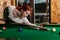 Attractive woman plays the game of snooker pool table