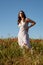 Attractive woman posing outdoor in poppy field in spring. Freedom outdoors, springtime