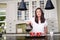 Attractive woman pouring homemade coffee for two in modern sunny kitchen