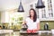 Attractive woman pouring homemade coffee for two in modern sunny kitchen