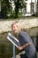 Attractive woman reads information board with indications of a sight