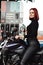 An attractive woman with red hairs sitting on her bike
