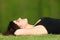 Attractive woman relaxed lying on the grass in a park