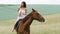 attractive woman riding brown horse