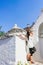 Attractive woman standing and smiling at Alberobello