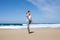 Attractive woman stretches on beach during holidays