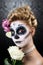 Attractive woman with sugar skull make-up