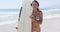 Attractive woman surfer posing with her board