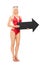 Attractive woman in swimsuit holding a big arrow