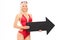 Attractive woman in swimsuit holding a black arrow pointing right