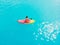 Attractive woman in swimwear floating on stand up paddle board on a quiet blue ocean. Sup surfing in tropical sea