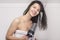 Attractive woman in a towel blow drying her hair