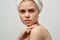 Attractive woman with towel on head naked shoulders pimples on face acne skin care