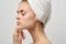 attractive woman with towel on head naked shoulders pimples on face acne skin care