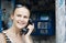 Attractive woman using a public telephone