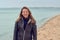 Attractive woman walking on a beach on a cloudy day