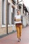attractive woman walking with shopping boxes